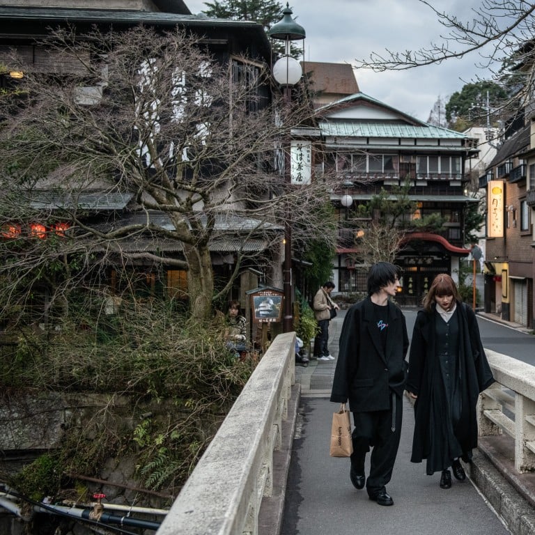 A couple walk over a bridge in Hakone, Japan. Hotels in the hot spring resort and elsewhere around the country are dealing with a surge in visitors. Photo: Getty Images